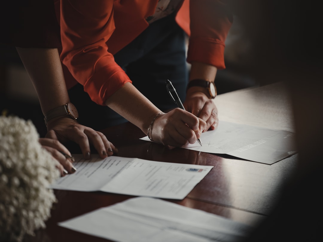 Buyer reviewing the lease length on a leasehold flat contract at a desk