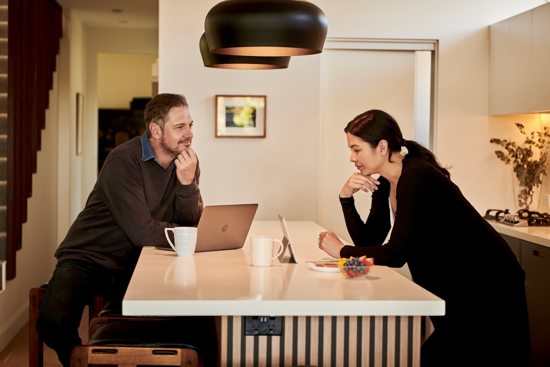 Couple calculating escalating ground rent costs on a leasehold flat