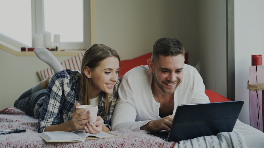Couple scrutinising a property listing on a laptop for red flags