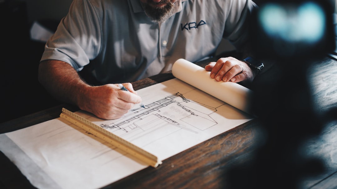 House hunter checking floorplan dimensions with a tape measure in a small bedroom