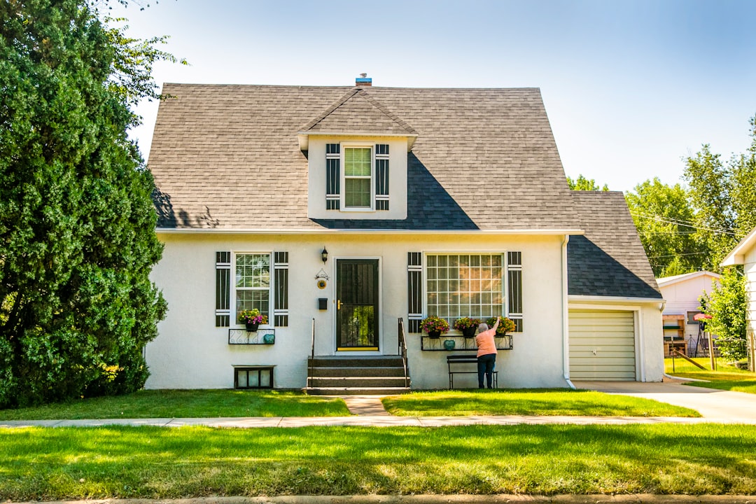 Buyer inspecting the exterior of a cash-buyers-only property with visible defects