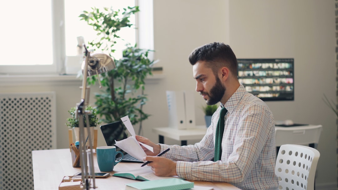 Buyer reading a modern method of auction legal pack and reservation terms