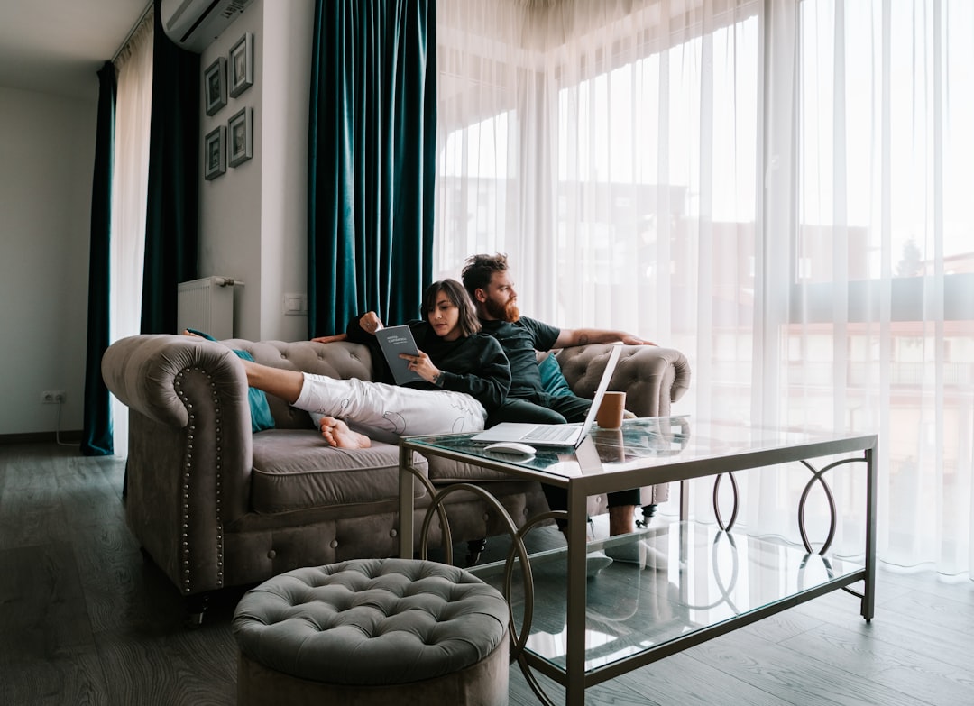 A couple reviewing their house buying budget together with a laptop and paperwork