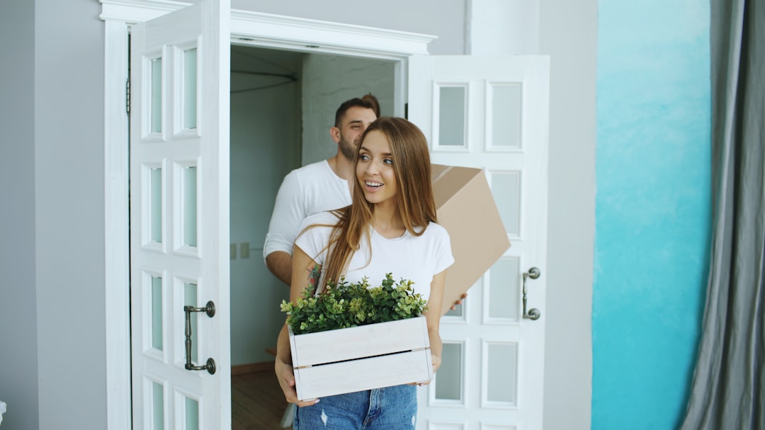 A couple viewing a house room by room with a checklist during a property viewing