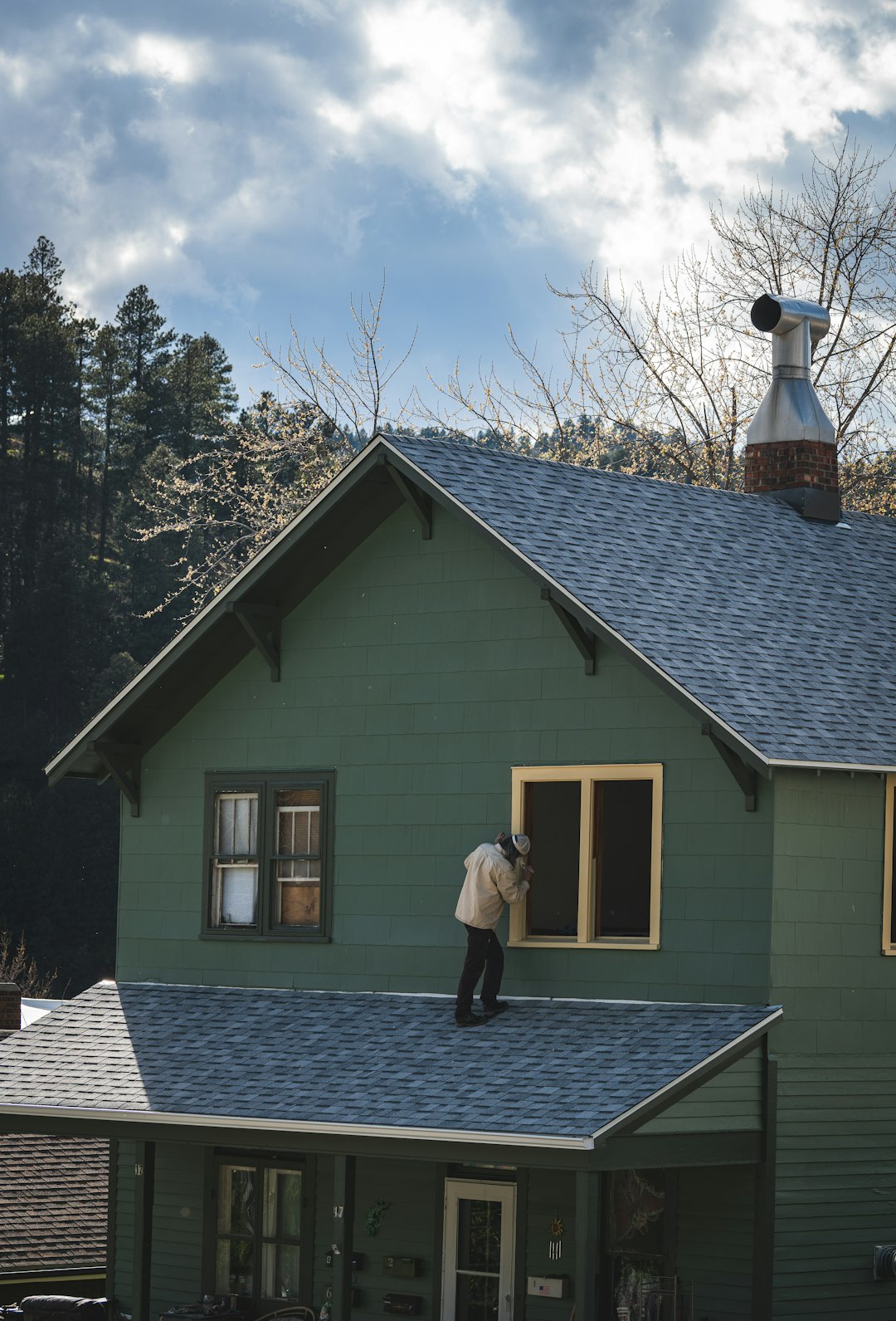 A surveyor carrying out a house survey while the buyer looks on