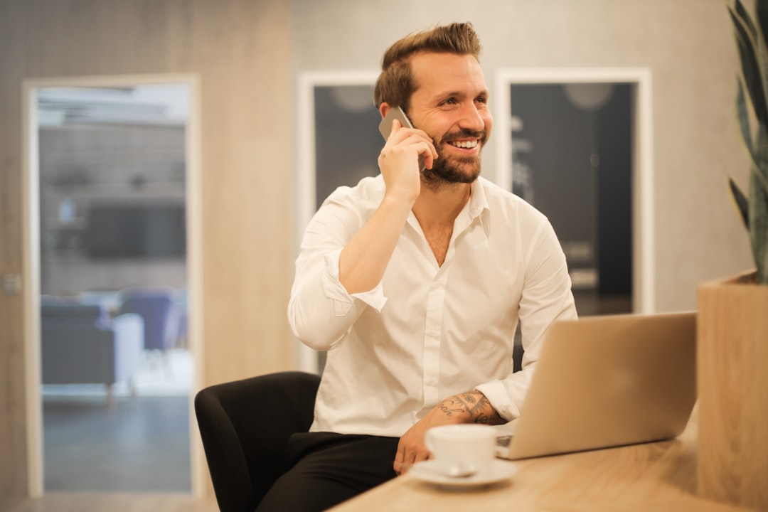 A home buyer on the phone to their surveyor, taking notes on the survey findings