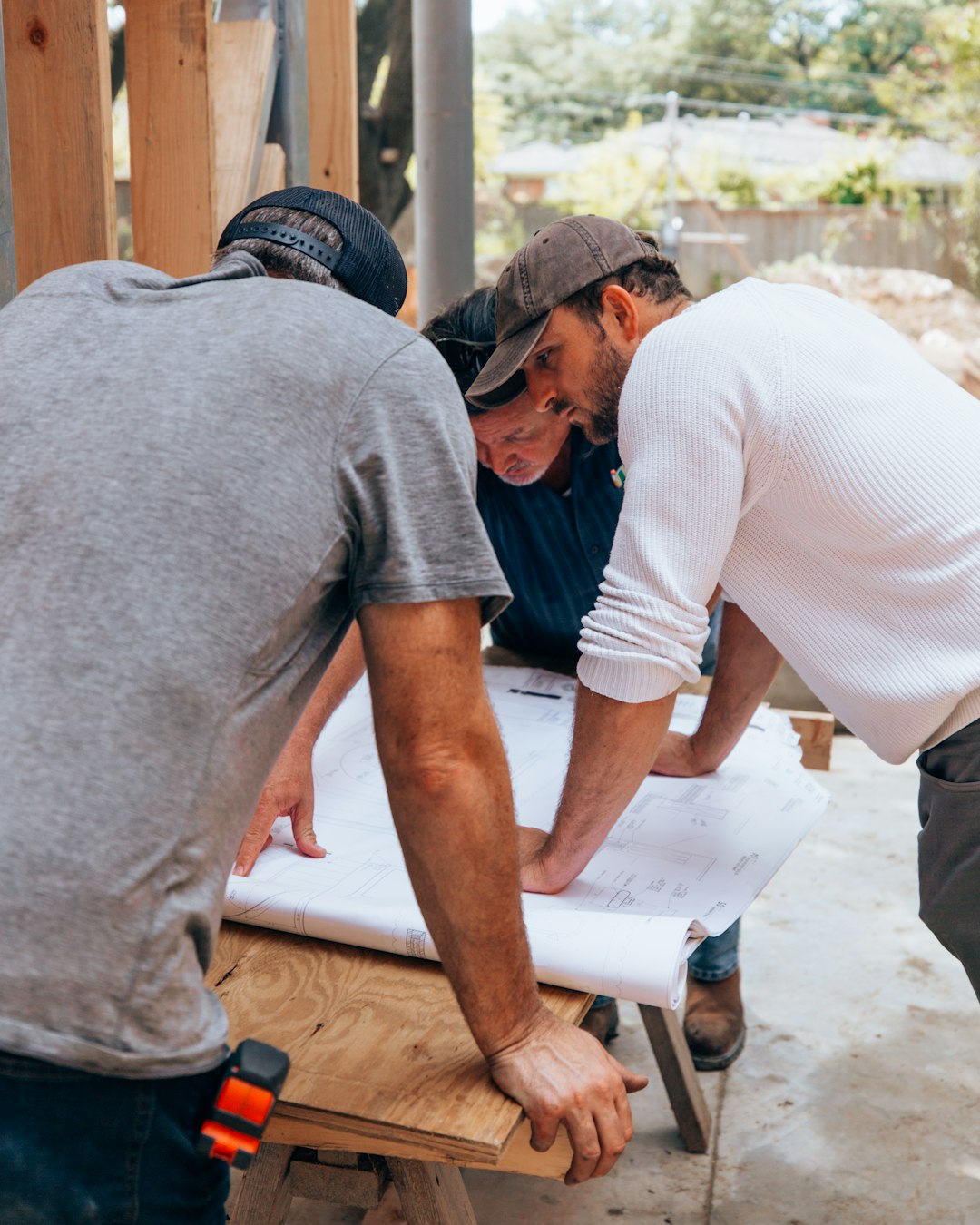 A builder giving a homeowner a repair quote for issues found in a house survey