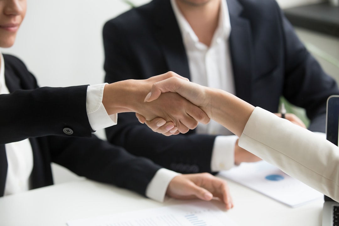 A buyer and estate agent agreeing a renegotiated house price after survey results