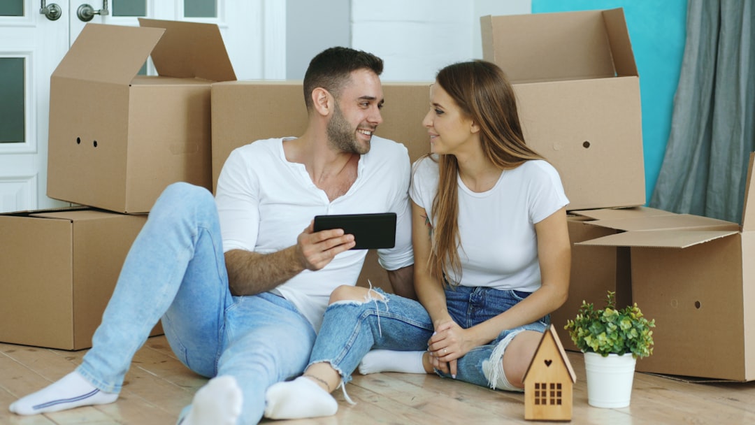 First-time buyers using apps on a phone to plan their home purchase