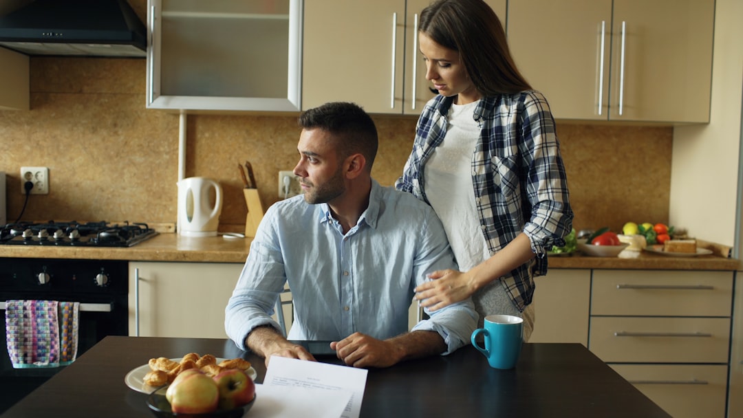 Couple reviewing their budget on a laptop while saving for a house deposit
