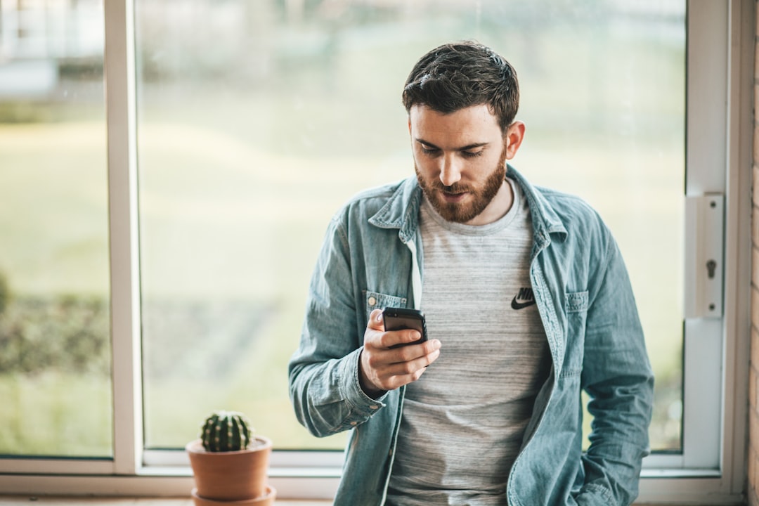 Man checking his credit score on a free credit report app before applying for a mortgage