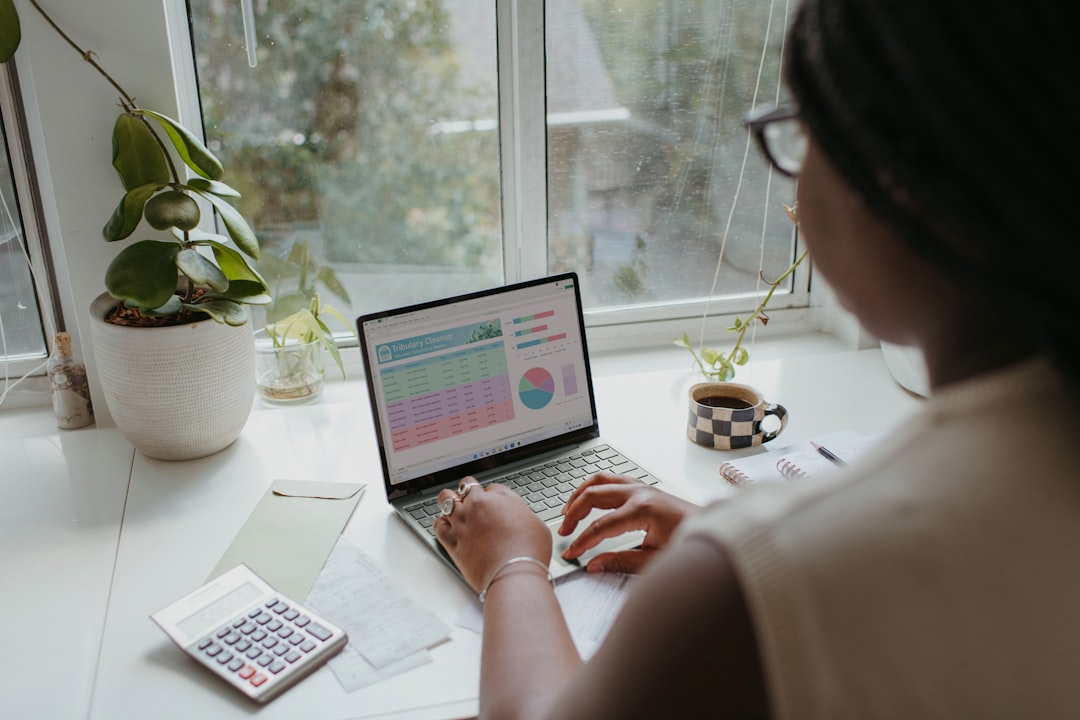 First-time buyer using an online mortgage affordability calculator at home