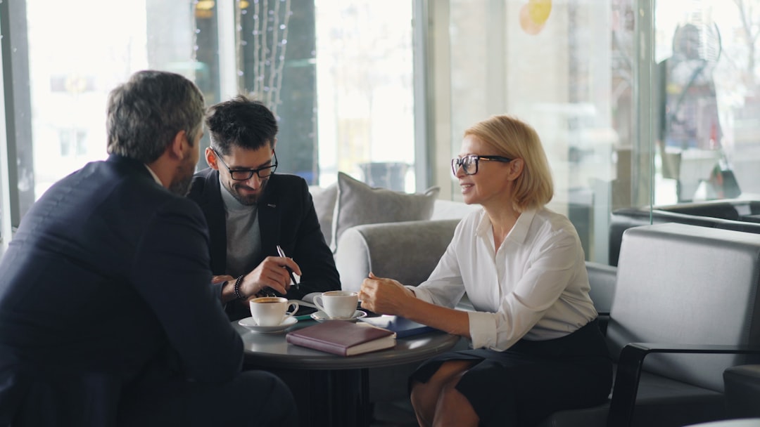 First-time buyer signing conveyancing solicitor instruction paperwork at a kitchen table