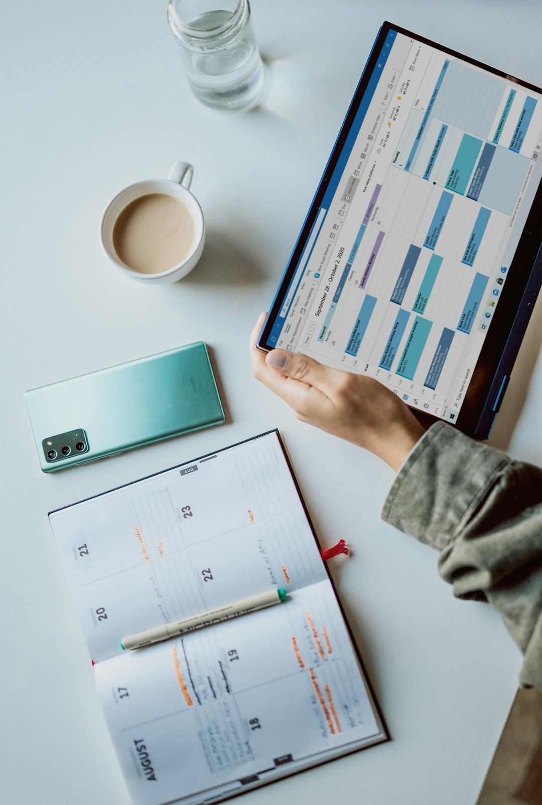 Buyer discussing a target completion timeline with an estate agent in a UK office