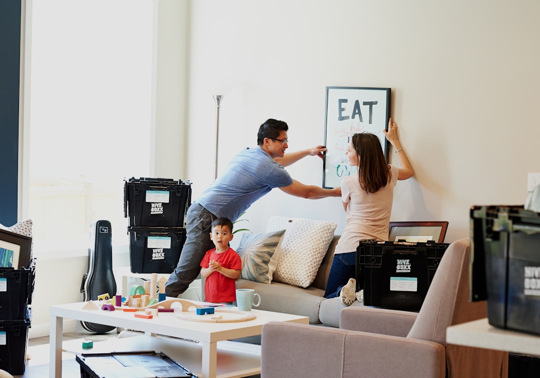 Couple asking an estate agent why the seller is moving during a house viewing