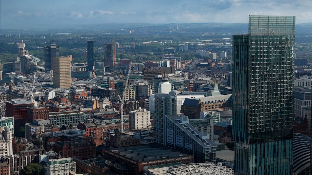 Manchester city centre apartment buildings under a bright sky, home to thousands of flat owners
