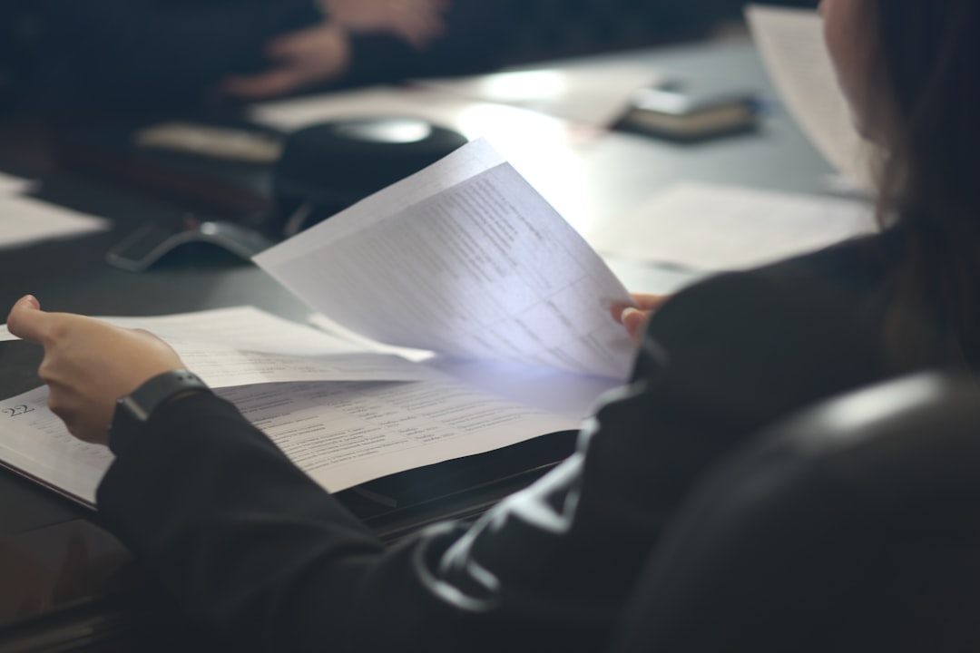 A buyer reviewing the lease documents for a Manchester flat at a kitchen table
