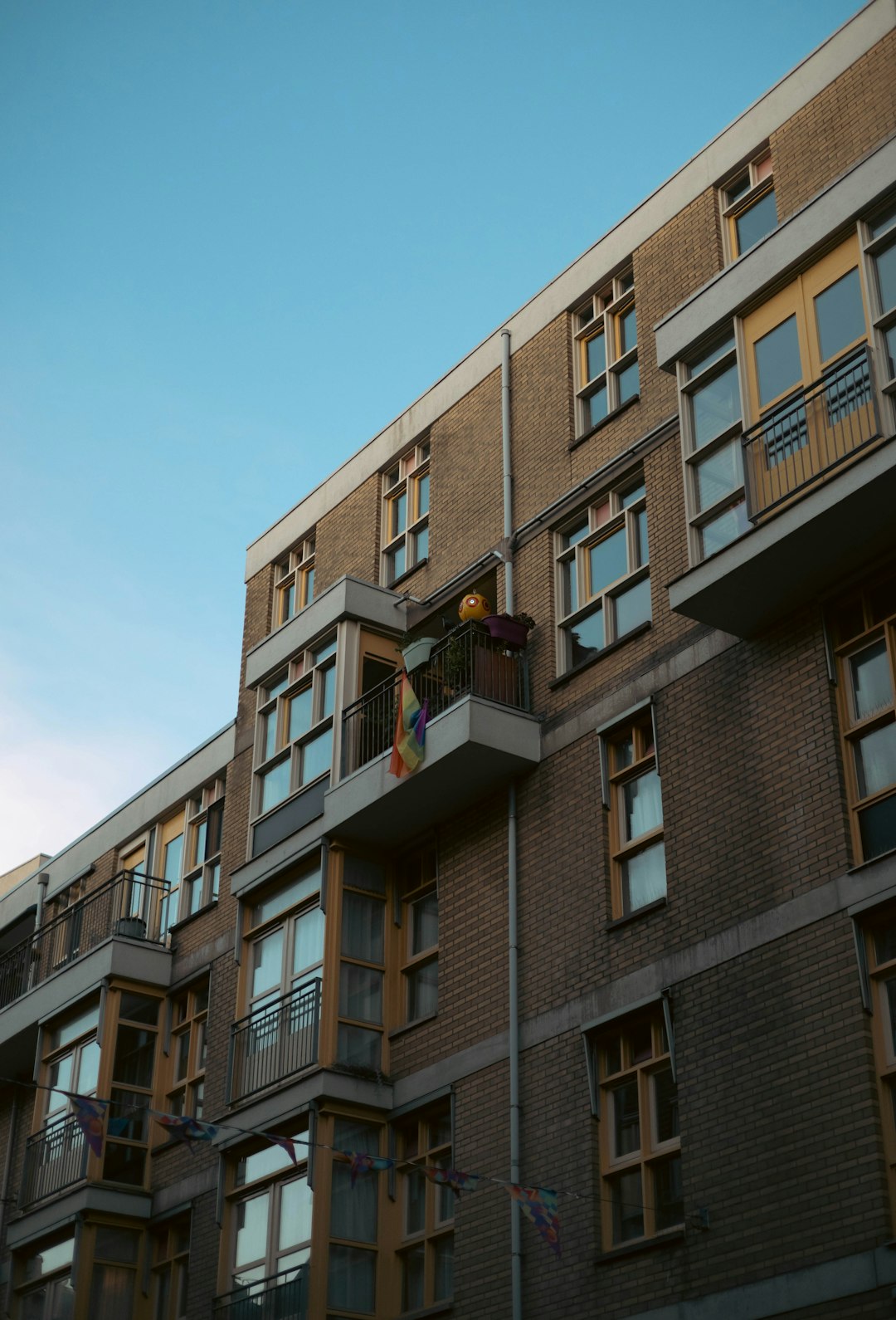 A professional inspecting the exterior of an apartment block ahead of major works