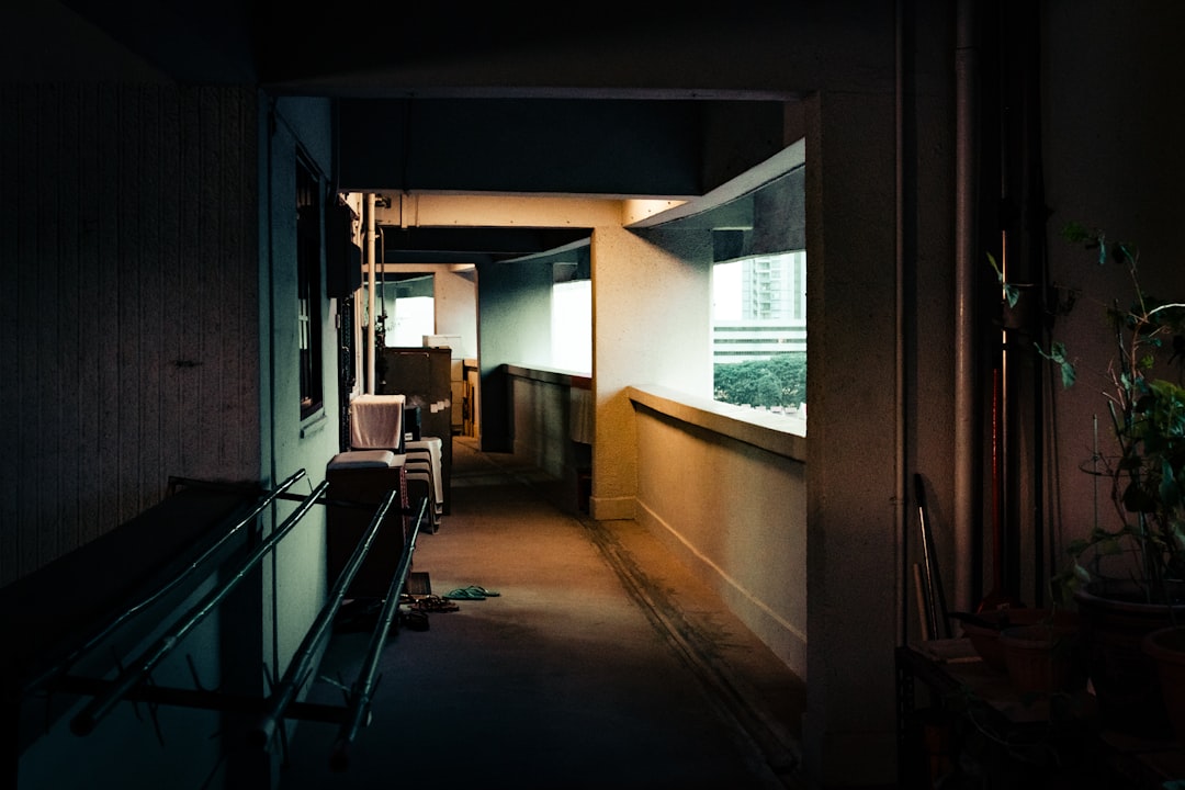 Neighbours chatting in a well-kept Manchester apartment building corridor