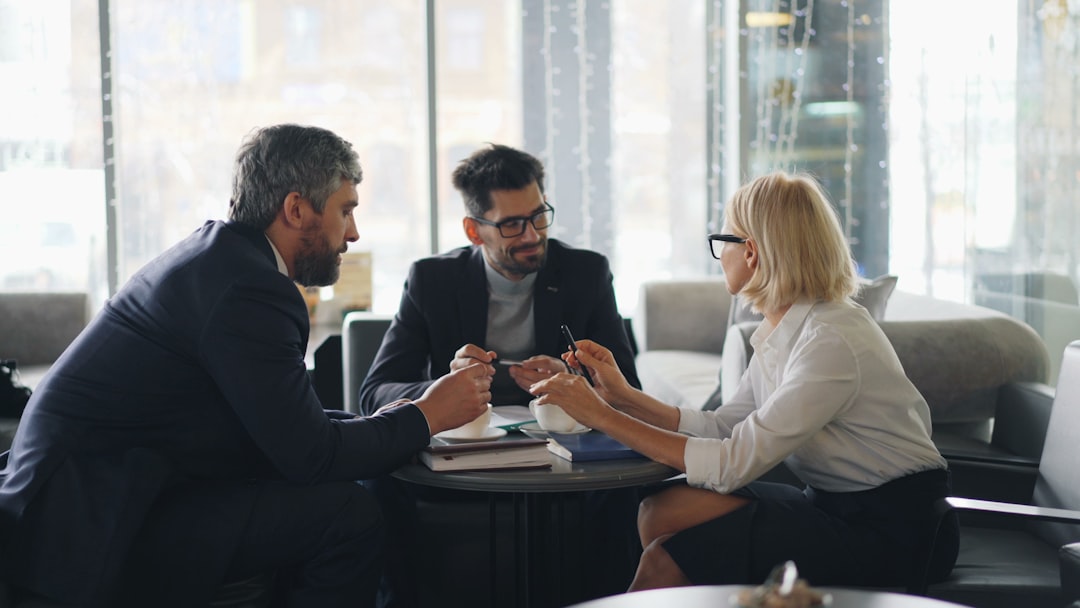 A mortgage broker discussing lending criteria for a Manchester flat with buyers